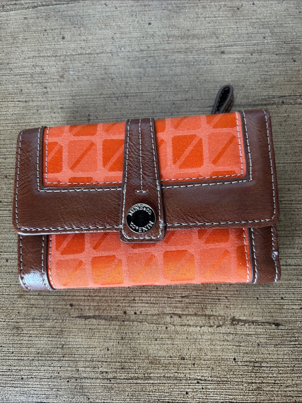 Vintage Nine & Co. Orange And Brown Leather Geometric Patterned Trifold Wallet.